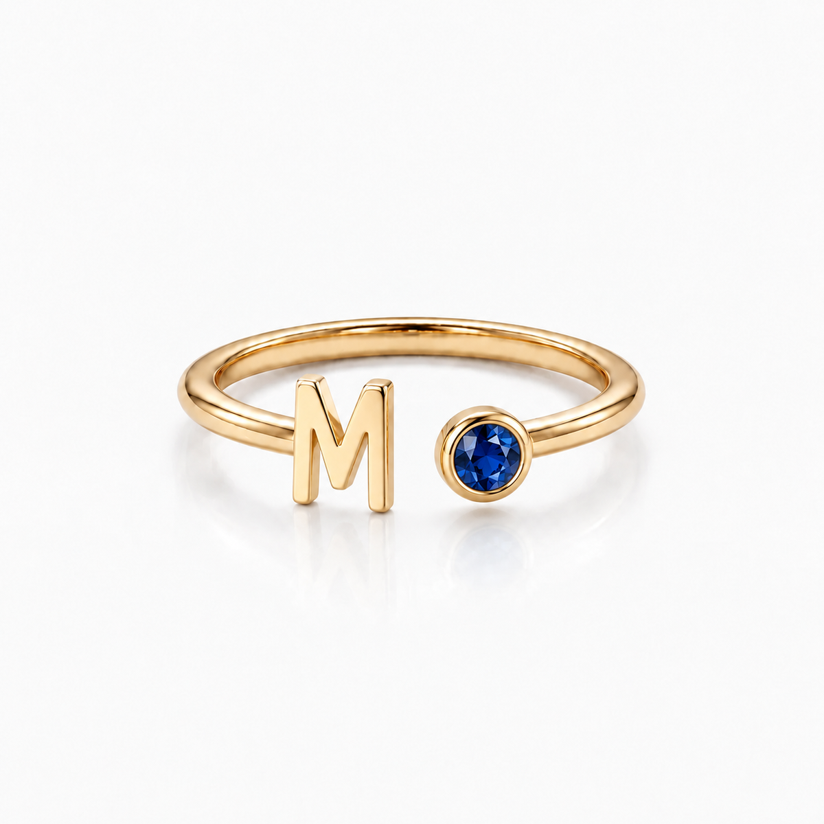 Gold Monty initial birthstone ring with letter M and blue birthstone